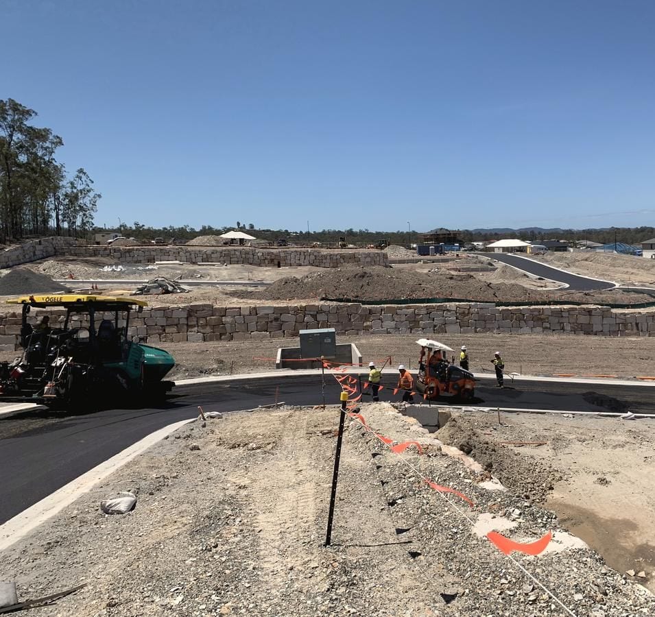 Asphalt paving crew sealing a new road at Holmview Estate